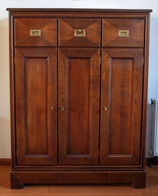 Cherry wood tableware cupboard with three doors and drawers.