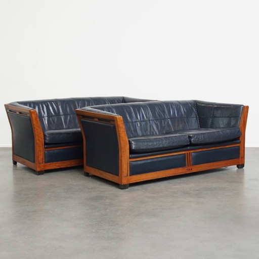2x 2.5-seater Schuitema Art Deco design sofa with woodwork and dark blue cowhide leather