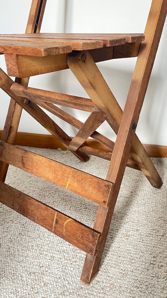 Image 1 of Antieke opklapbare houten stoel, een praktische en geometrische zitplaats. We zijn helemaal gecharmeerd van deze antieke stoel.