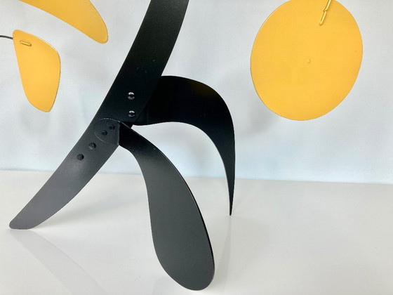 Image 1 of Black stabile with 9 yellow discs and leaves