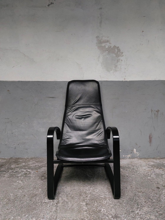 Image 1 of Black leather relax chair + Poef, 1989