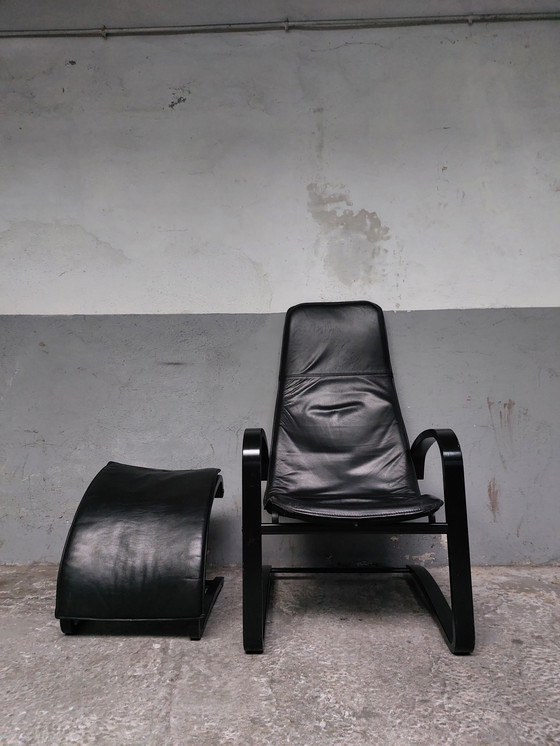 Image 1 of Black leather relax chair + Poef, 1989