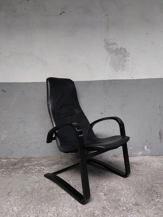 Image 1 of Black leather relax chair + Poef, 1989