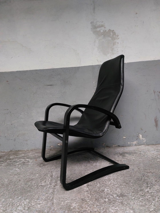 Image 1 of Black leather relax chair + Poef, 1989