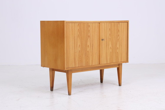 Image 1 of Hellerau 602 | Een ladekast jaren 60 | Mid Century gangkast vintage opbergruimte retro jaren 70 Senesche hout Franz Ehrlich