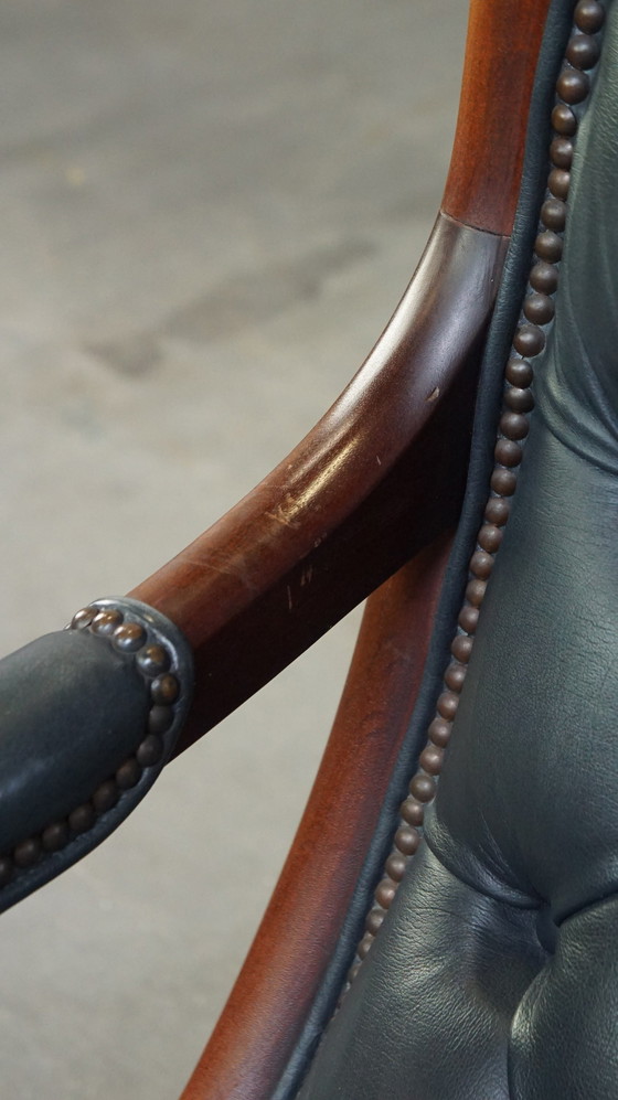 Image 1 of Donkerblauwe Chesterfield Fauteuil Gemaakt Van Rundleer En Gecombineerd Met Hout