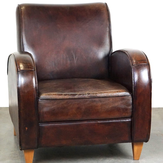 Image 1 of Donker kleurige schapenleren fauteuil