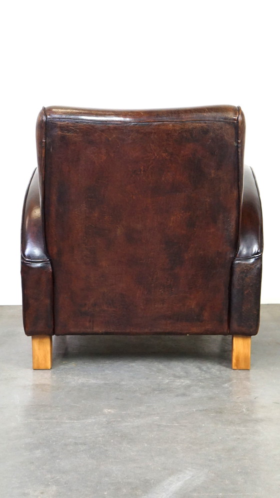 Image 1 of Donker kleurige schapenleren fauteuil