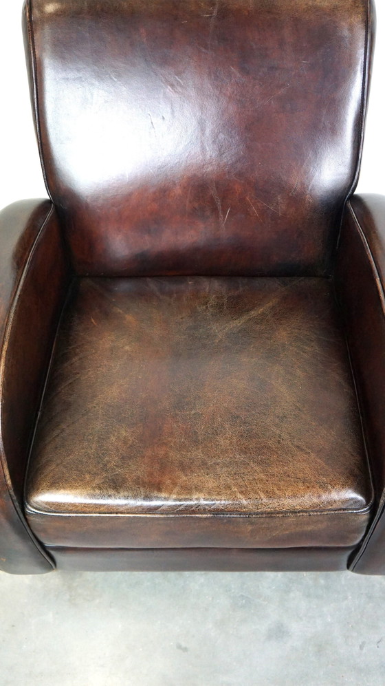 Image 1 of Donker kleurige schapenleren fauteuil