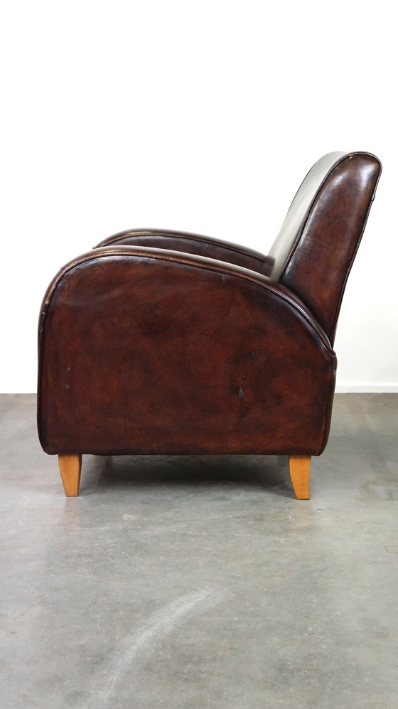 Image 1 of Donker kleurige schapenleren fauteuil