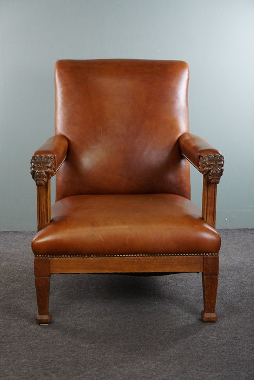 Fauteuil met leeuwenkoppen opnieuw bekleed met cognac kleurig rundleer