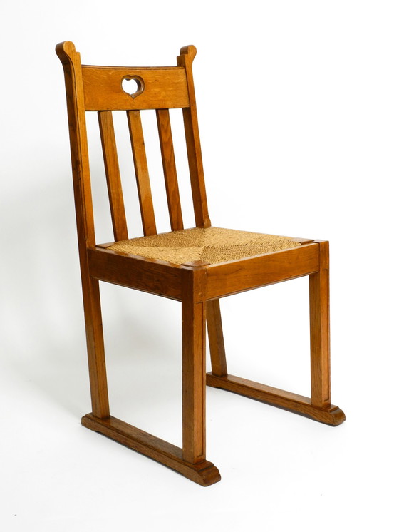 Image 1 of Een paar Mid Century eiken stoelen met sledepoten en rieten zittingen