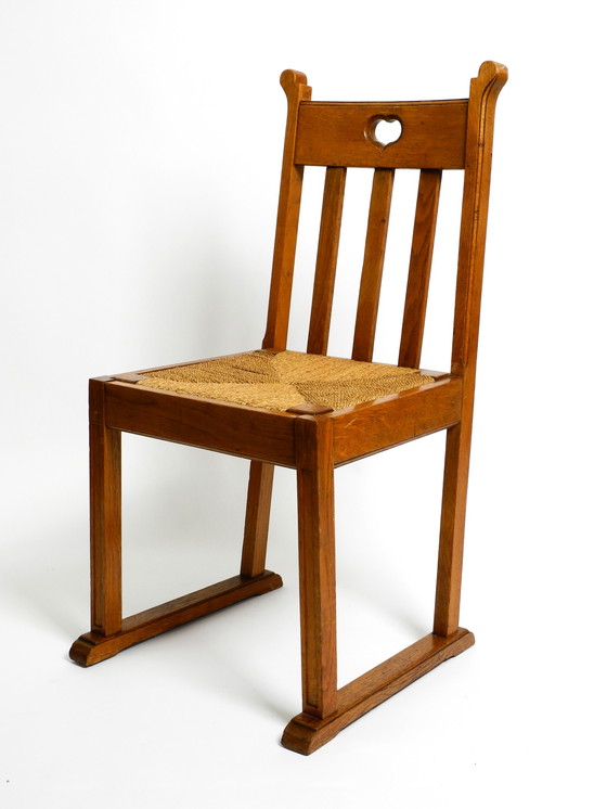 Image 1 of Een paar Mid Century eiken stoelen met sledepoten en rieten zittingen