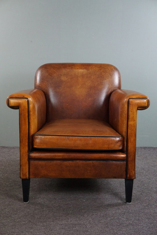 Schapenleren ArtDeco design fauteuil met accenten rondom