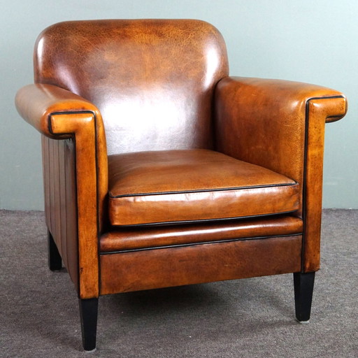 Schapenleren ArtDeco design fauteuil met accenten rondom