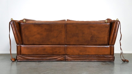 Image 1 of Complete set cognac kleurige rundleren kasteelbank en fauteuils