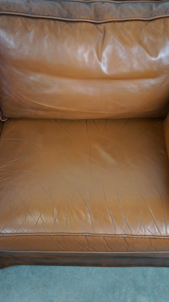 Image 1 of Complete set cognac kleurige rundleren kasteelbank en fauteuils