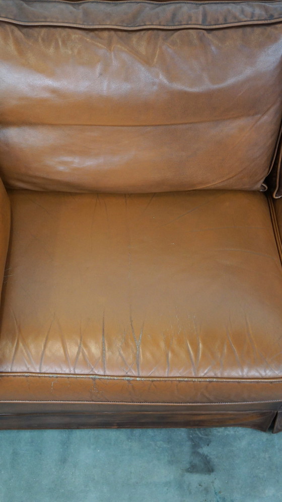 Image 1 of Complete set cognac kleurige rundleren kasteelbank en fauteuils