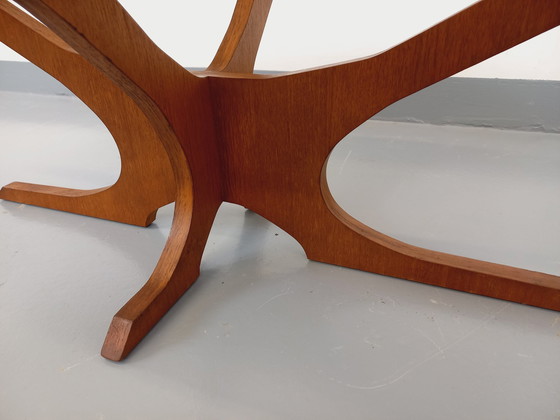 Image 1 of Hugues Poignant Vintage Ovale Salontafel in Teak en Rookglas uit de jaren 60 en 70
