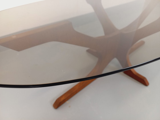 Image 1 of Hugues Poignant Vintage Ovale Salontafel in Teak en Rookglas uit de jaren 60 en 70