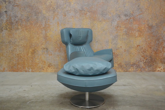 Image 1 of Leolux Ottana draaifauteuil met hocker en kussen