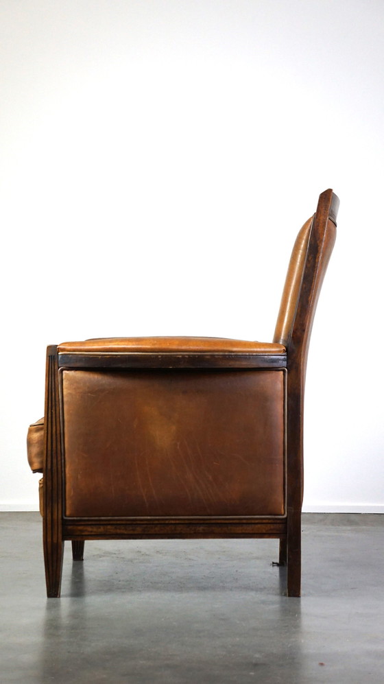 Image 1 of Vintage schapenleren design fauteuil met hoge rug en hout accenten