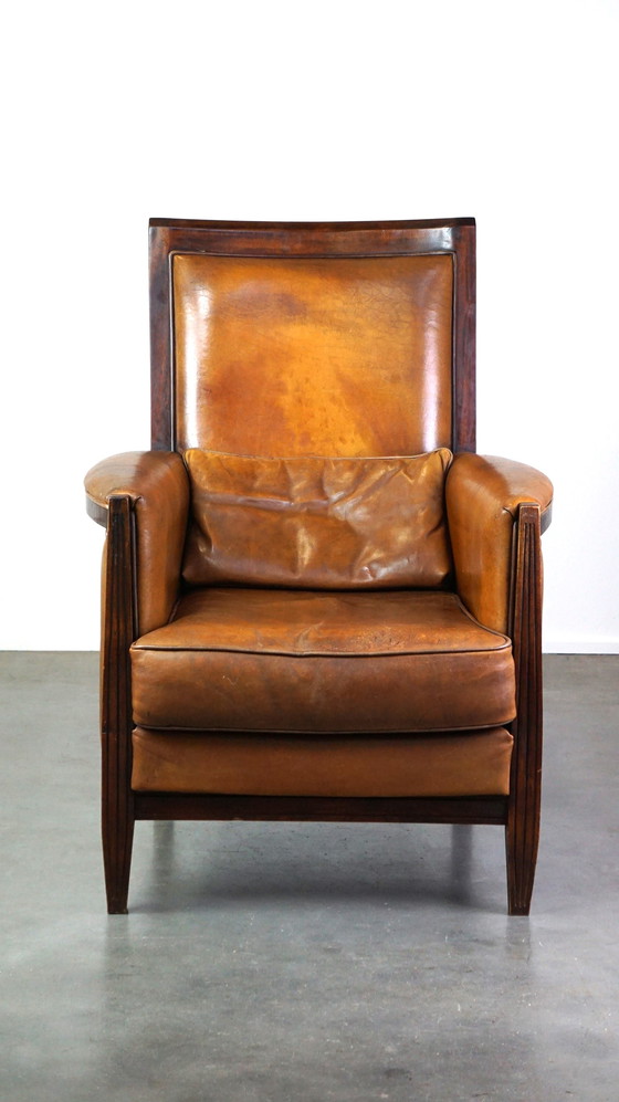 Image 1 of Vintage schapenleren design fauteuil met hoge rug en hout accenten