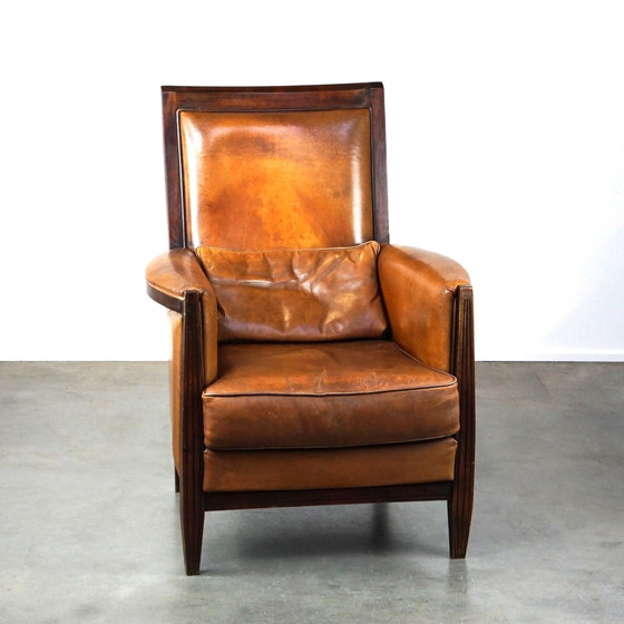 Image 1 of Vintage schapenleren design fauteuil met hoge rug en hout accenten