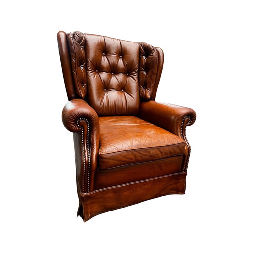 Comfortabele fauteuil van echt leer met gebruikssporen