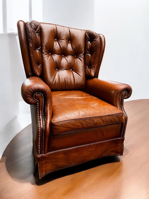 Comfortabele fauteuil van echt leer met gebruikssporen