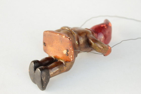 Image 1 of Antieke Heissner tuinkabouter op een schommel