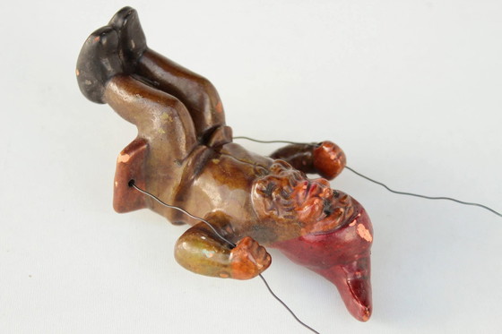 Image 1 of Antieke Heissner tuinkabouter op een schommel