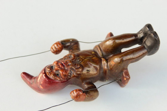 Image 1 of Antieke Heissner tuinkabouter op een schommel