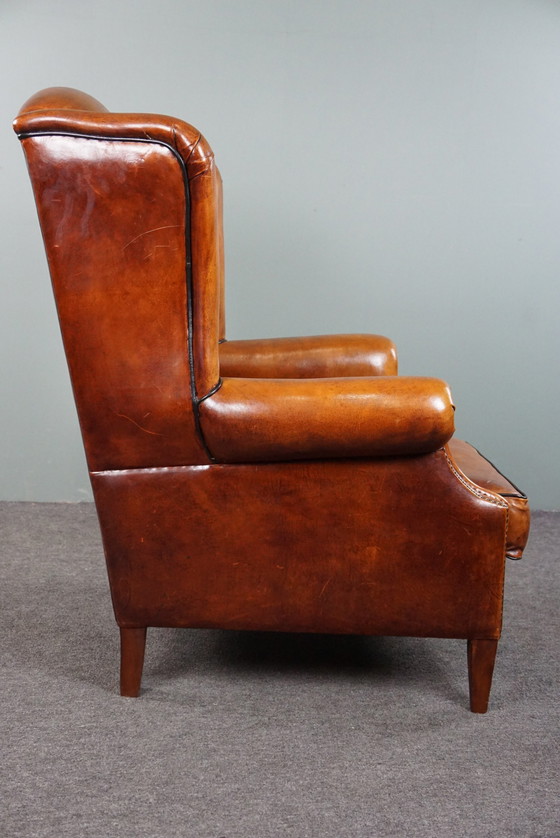 Image 1 of Schapenleren oorfauteuil met zwarte biezen