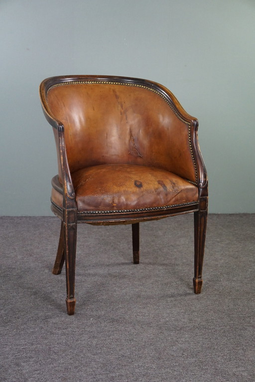 Cognac kleurige lederen tubchair met patina