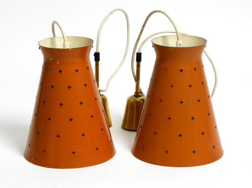 Pair of Italian Mid Century Modern Diabolo design perforated sheet metal pendant lamps in brick red