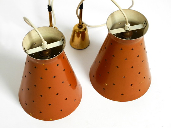 Image 1 of Pair of Italian Mid Century Modern Diabolo design perforated sheet metal pendant lamps in brick red