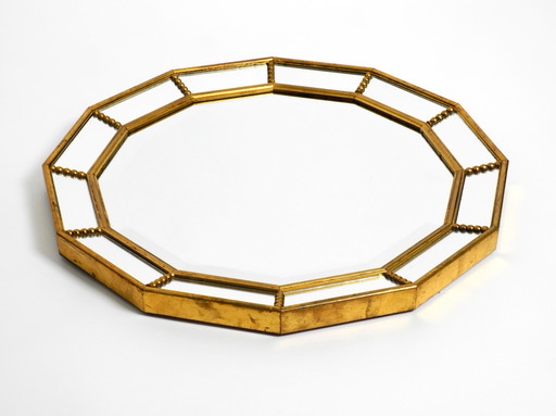 Beautiful Italian 12 sided gold-plated wall mirror with facet cut from the 1960s