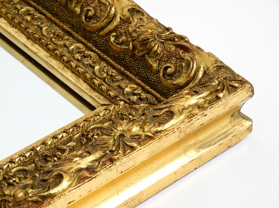 Image 1 of Mid Century wall mirror from Italy with an ornate, gold-plated wooden frame