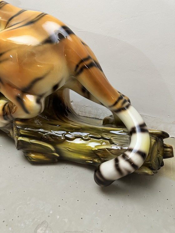 Image 1 of Prowling tiger on tree trunk ceramic