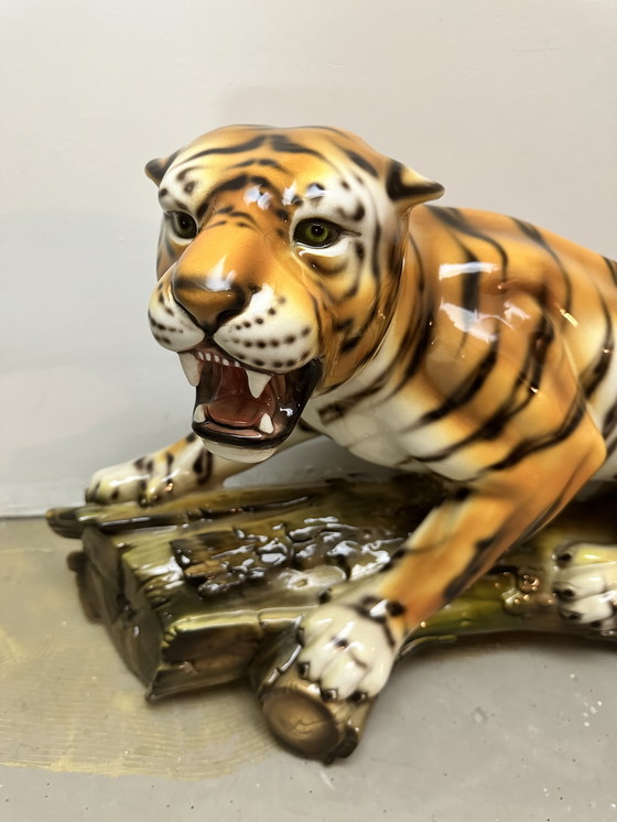 Image 1 of Prowling tiger on tree trunk ceramic