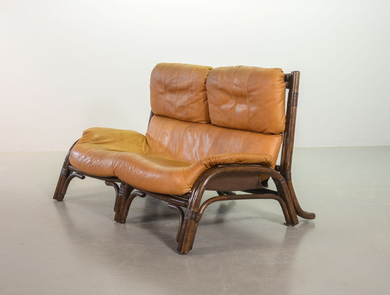 Image 1 of Brutalist Bentwood Loveseat Bamboo Sofa and Lounge Chair with Caramel Leather Upholstery, 1960s. 