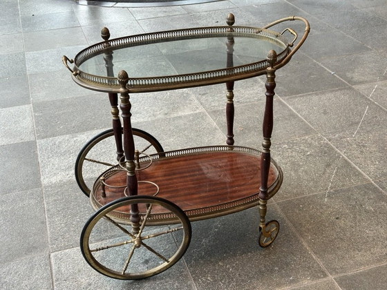 Image 1 of Neoclassical Oval Scroll Table Of Brass And Mahogany With Double Removable Trays. French Work Of The Maison Baguès. Circa 1940.