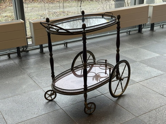 Image 1 of Neoclassical Oval Scroll Table Of Brass And Mahogany With Double Removable Trays. French Work Of The Maison Baguès. Circa 1940.