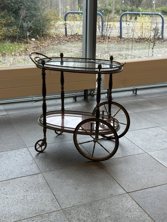 Image 1 of Neoclassical Oval Scroll Table Of Brass And Mahogany With Double Removable Trays. French Work Of The Maison Baguès. Circa 1940.