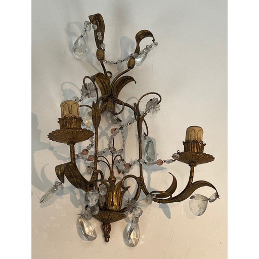 Pair of gilded metal and crystals wall sconces. French work in the style of Maison Baguès