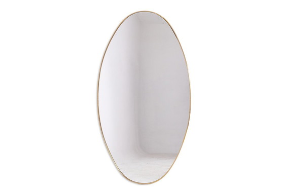 Image 1 of Oval-shaped mirror set with a gilded brass rod. Circa 1970.