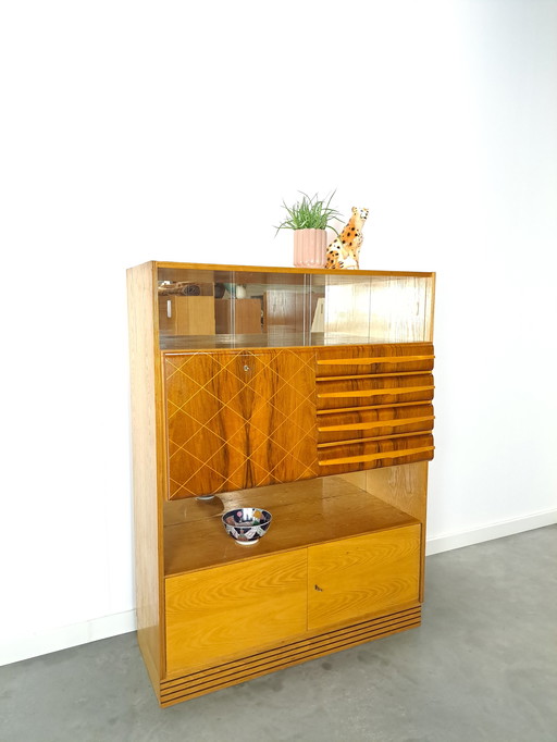 Veneer bar cabinet with round shapes and mirror wall