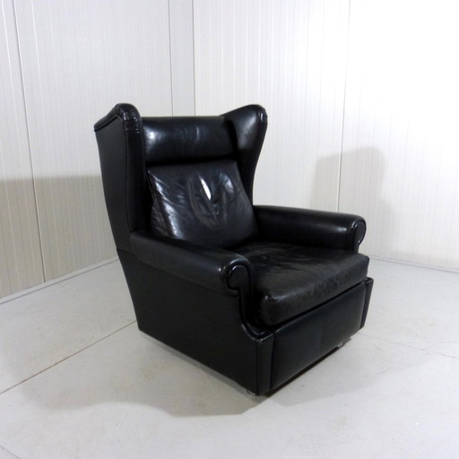 Black leather vintage wingback armchair on wheels 1960's
