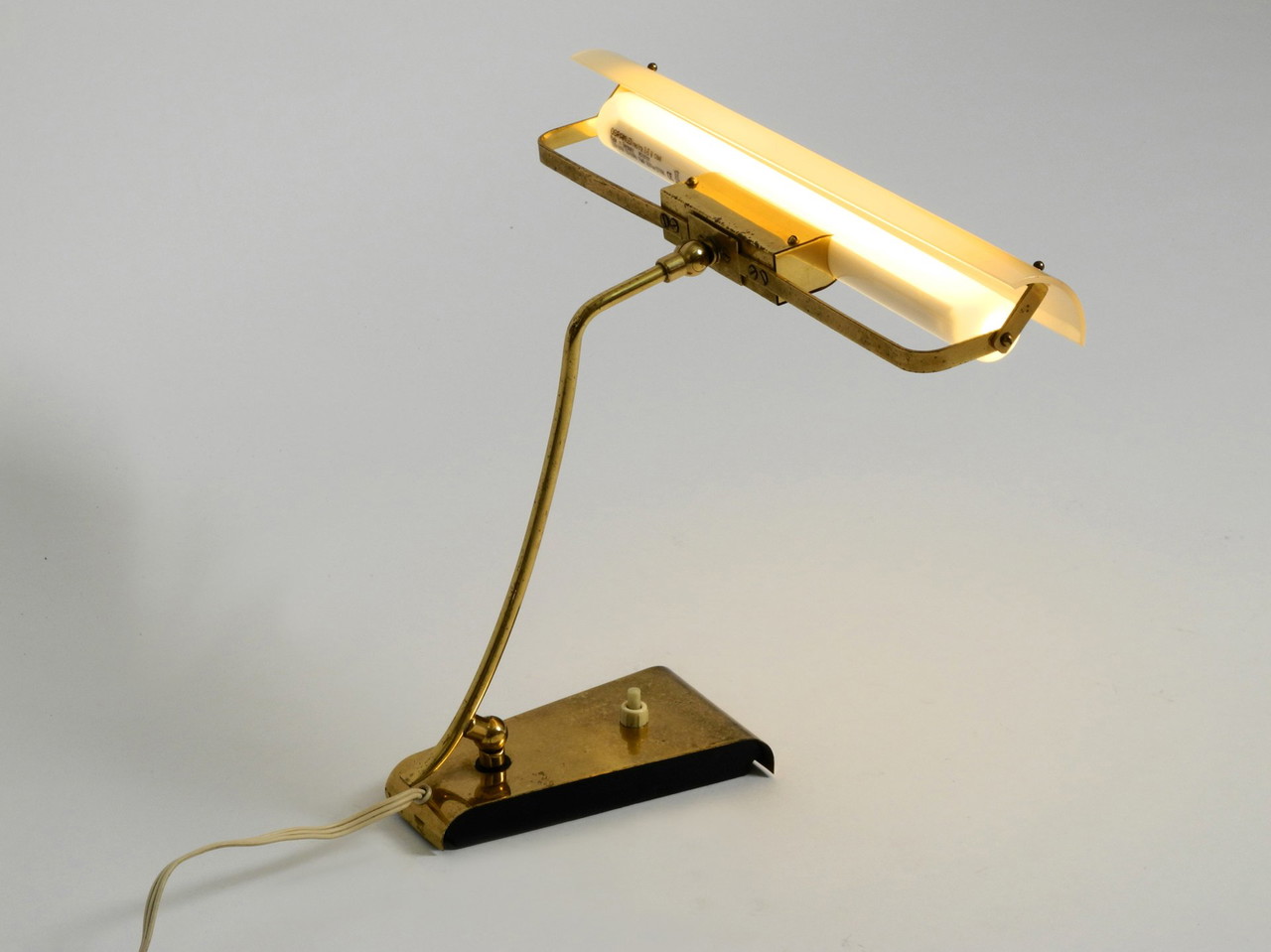 Mid Century Modern brass desk lamp with a plexiglass shade and